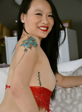 Slim asian MILF in sexy red lingerie smiles with joy while posing naked