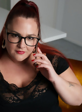 Glasses-wearing BBW posing and squeezing her boobies too