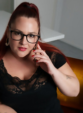 Glasses-wearing BBW posing and squeezing her boobies too