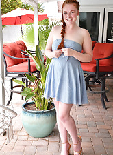 Pale redhead plays with her hair on top of her pussy