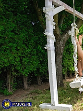 Lesbian couple tease and play on garden swing
