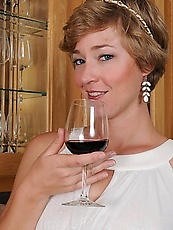 Elegant mature woman is fond of wine and expensive jewelry