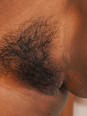 Ebony babe exposes hairy pussy and natural tits in raw solo tease with spread pose