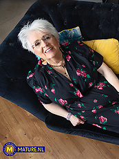 ature granny solo tease on couch with bush, sagging tits, pussy out, spread pose