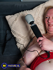 Mature milf in red lingerie with saggy tits and stockings spreads legs for solo wand tease