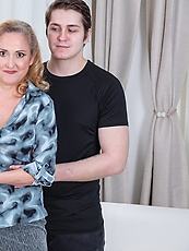 Mature milf teasing in stockings and heels, bare breasts and ass out