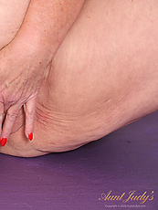 Mature yoga granny undresses for naked solo fingering shaved pussy