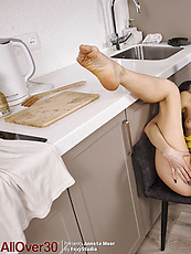 Milf in kitchen apron solo tease with bushy pussy spread pose and tits out